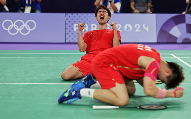 Wei Keng Liang and Chang Wang of China celebrate after winning the match against Fajar Alfian and Muhammad Rian Ardianto of Indonesia during the men's doubles badminton quarterfinals at the Porte de la Chapelle Areana in Paris, France on August 01, 2024. (Photo by Ann Wang/Reuters)