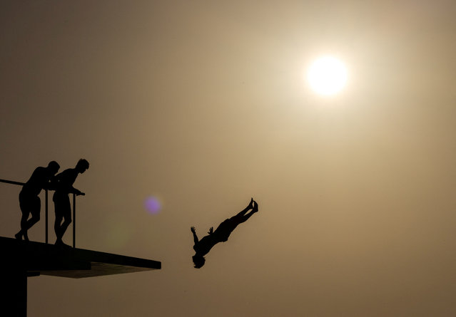 A person jumps into the Adriatic Sea as temperature rises in Zadar, Croatia, on July 13, 2024. (Photo by Antonio Bronic/Reuters)