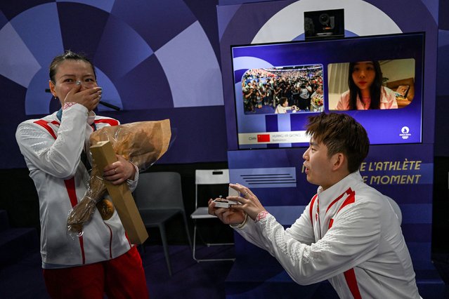 Chinese badminton player Liu Yuchen proposes to his girlfriend, Huang Yaqiong, after she and Zheng Siwei won Olympic gold in mixed doubles on Friday, August 2, 2024. (Photo by Arun Sankar/AFP Photo)