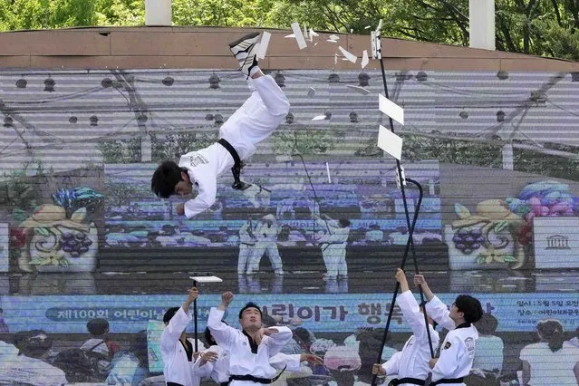 A Taekwondo practitioner breaks wooden plates during an event to celebrate Children's Day at the Children's Grand Park in Seoul, South Korea, Thursday, May 5, 2022. (Photo by Ahn Young-joon/AP Photo)