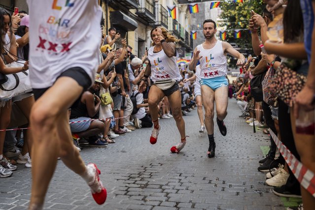 During Madrid's pride week, participants compete during the annual high heel race in Madrid, Spain, Thursday, July 29, 2023. Competitors must wear shoes with a heel of a minimum of 15 centimetres (5.9 inches). (Photo by Bernat Armangue/AP Photo)