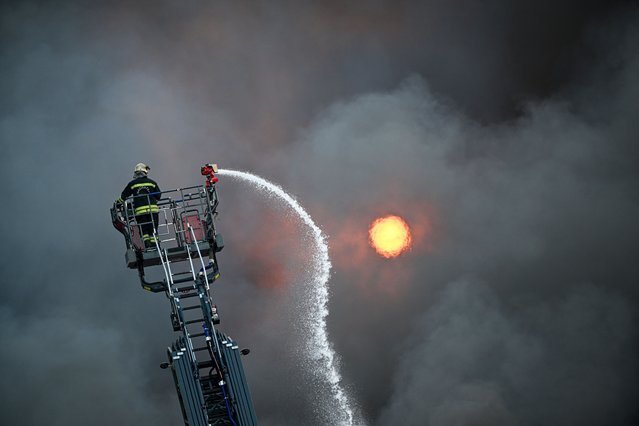 Firefighters respond to a blaze at a carpet factory in the 2nd Organized Industrial Zone in Gaziantep, Turkiye on August 15, 2024. Teams continued their efforts to bring the fire under control. (Photo by Adsiz Gunebakan/Anadolu via Getty Images)