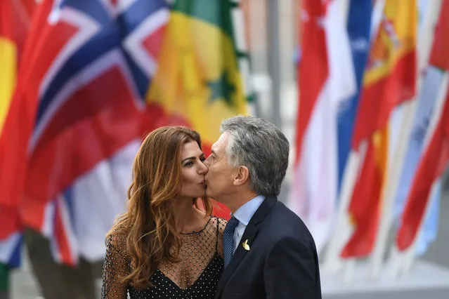 Argentinia's President Mauricio Macri and his wife Juliana Awada kiss as they arrive for a concert at the Elbphilharmonie concert hall during the G20 Summit in Hamburg, Germany, on July 7, 2017. Leaders of the world's top economies will gather from July 7 to 8, 2017 in Germany for likely the stormiest G20 summit in years, with disagreements ranging from wars to climate change and global trade. (Photo by Patrik Stollarz/AFP Photo)