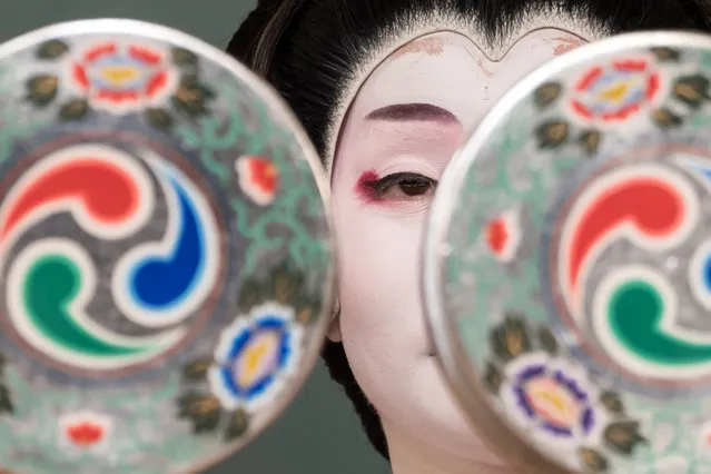 A performing artist and entertainer trained in traditional styles called “geisha” performs a dance on the stage during a rehearsal at Shinbashi Enbujo Theater on May 20, 2022 in Tokyo, Japan. Tokyo's geisha association in the Shinbashi area opened their stage, called “Azuma Odori”, to the public for the first time in three years due to the coronavirus pandemic. While geisha from the association entertain customers exclusively at traditional Japanese high-end dining restaurants, they also perform on stage once a year for the public, a practice that had been suspended due to the COVID-19 pandemic until this year. (Photo by Tomohiro Ohsumi/Getty Images)