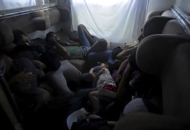 Syrian migrants rest on a train as it travels through Macedonia August 2, 2015. (Photo by Ognen Teofilovski/Reuters)