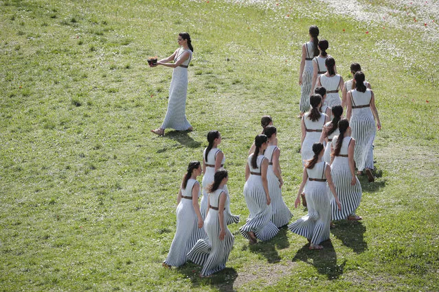 Greek actress Xanthi Georgiou, the High Priestess, carries the flame of the 2020 Tokyo Olympic Games during the dress rehearsal of the flame lighting ceremony at the closed Ancient Olympia site, birthplace of the ancient Olympics in southern Greece, Wednesday, March 11, 2020. Greek Olympic officials are holding a pared-down flame-lighting ceremony for the Tokyo Games due to concerns over the spread of the coronavirus. Both Wednesday's dress rehearsal and Thursday's lighting ceremony will be closed to the public, while organizers have slashed the number of officials from the International Olympic Committee and the Tokyo Organizing Committee, as well as journalists at the flame-lighting. (Photo by Thanassis Stavrakis/AP Photo)