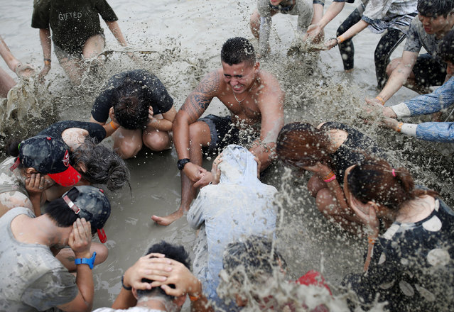 Tourists play in a mud pool during the Boryeong Mud Festival at Daecheon beach in Boryeong, South Korea, July 16, 2016. (Photo by Kim Hong-Ji/Reuters)