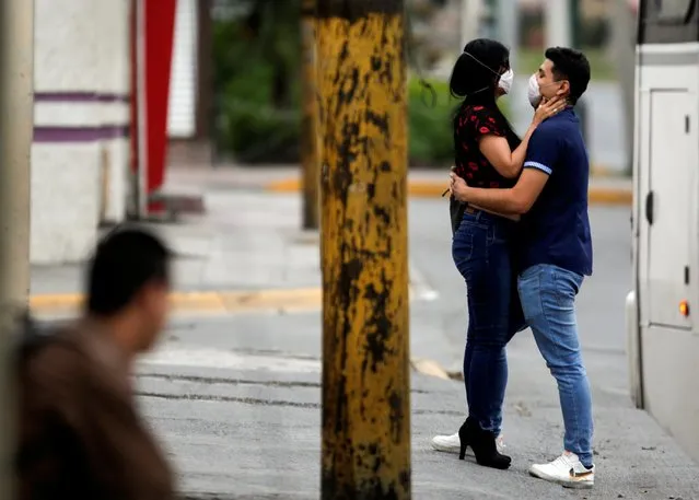 A couple wearing face masks embrace as the spread of coronavirus disease (COVID-19) continues, in Escobedo, on the outskirts of Monterrey, Mexico on March 29, 2020. (Photo by Daniel Becerril/Reuters)