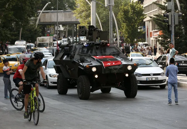 A police APC drives in the city center in Ankara, Turkey, Friday, July 22, 2016. Some Muslim faithful in Ankara welcomed Friday a declaration of a state of emergency by the top authorities, a move that gives President Recep Tayyip Erdogan sweeping powers in ruling the country. (Photo by Burhan Ozbilici/AP Photo)