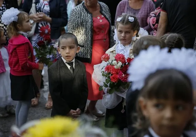 First graders wait for a festive ceremony to mark the start of another school year in Slaviansk, September 1, 2014. (Photo by Gleb Garanich/Reuters)