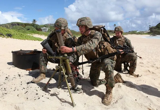 U.S. Marines set up a mortar defense during a simulated beach assault at Marine Corps Base Hawaii with the 3rd Marine Expeditionary Unit during the multi-national military exercise RIMPAC in Kaneohe, Hawaii, July 30, 2016. (Photo by Hugh Gentry/Reuters)
