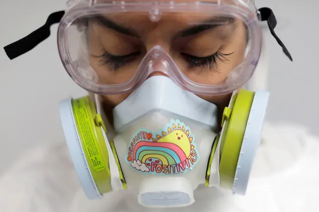 Alisha Narvaez, 36, the manager at International Funeral & Cremation Services, a funeral home in Harlem, poses for a photo in her personal protective equipment, before embalming a deceased person, during the coronavirus disease (COVID-19) outbreak, in Manhattan, New York City, New York, U.S., April 9, 2020. At the beginning of the pandemic, Narvaez sent her 17-year-old daughter to live with her twin sister, but after two weeks the distance was too much.  “It's always just been me and her and she wanted to come home”, said Narvaez. “I gotta make sure I keep healthy just not to harm her”, she added. “Although she's been in quarantine for several weeks, every day I come home from work is Day Zero for her”. (Photo by Andrew Kelly/Reuters)