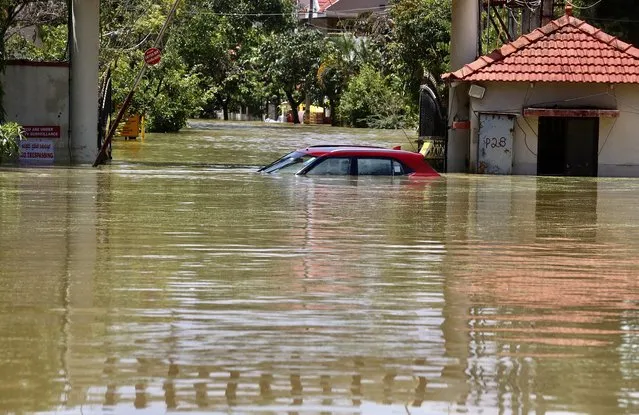 A car submerged at a flooded area following overnight heavy rainfall, in Bangalore, India, 05 September 2022. According to Karnataka State Natural Disaster Monitoring Centre (KSNDMC), at least 96 people lost their lives in separate incidents since 01 June as heavy rain wreaked havoc across Karnataka. India Meteorological Department (IMD) said Bengaluru received 131.6 mm of rainfall and has issued a red alert (extremely heavy rainfall) for next few days. (Photo by Jagadeesh N.V./EPA/EFE)
