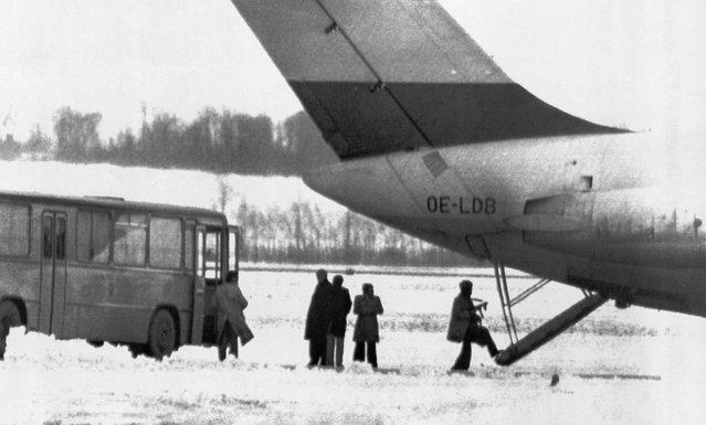 Six terrorists took over the OPEC headquarters in Vienna, Austria, on December 21, 1975, and held dozens of people hostage, including several OPEC oil ministers. Here, the attackers are seen boarding a DC-9 aircraft they had demanded to fly them to Algeria. Mediators from the Interior Ministry stand at center as an armed terrorist boards the plane. Three people were killed in the initial attack, but after negotiations, all remaining hostages and terrorists walked away just days later. (Photo by Bettmann Archive/Getty Images)