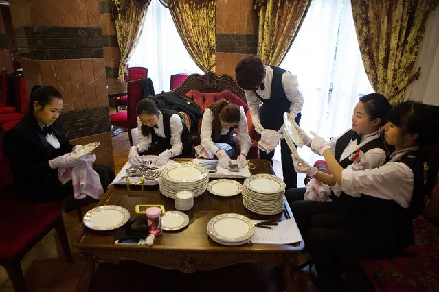 Butlery students polish china and silverware in preparation for a formal dinner at The International Butler Academy China on September 16, 2014 in Chengdu, China. (Photo by Taylor Weidman/Getty Images)