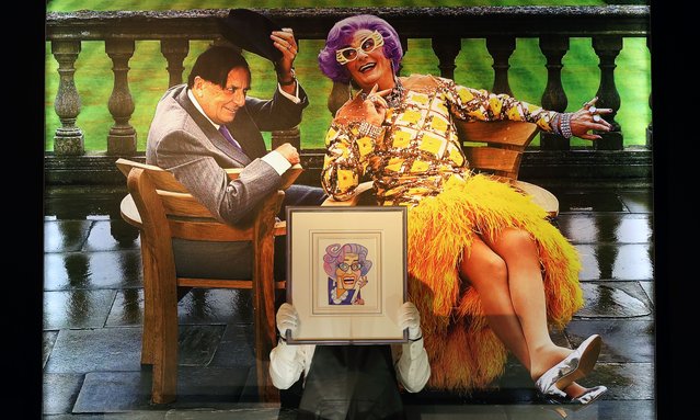 A staff member of Christie's auction house holds a carton drawing by Barry Humphries during a “Barry Humphries: The Personal Collection” preview in London, Britain, 07 February 2025. The collection goes under the hammer at auction in London on 13 February 2025. (Photo by Andy Rain/EPA/EFE)