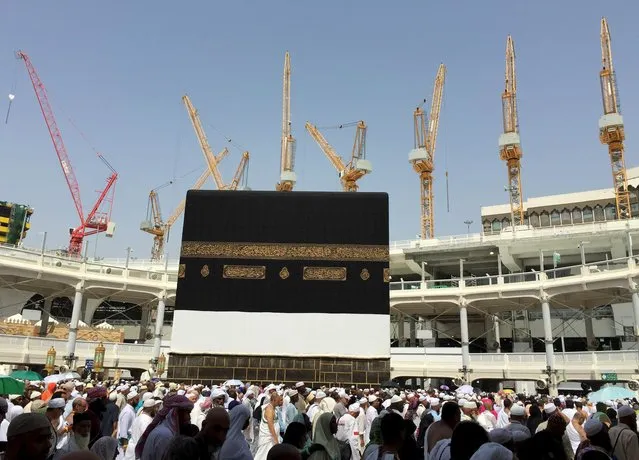 Cranes are seen as Muslim pilgrims perform Haj tasks in the Grand Mosque in the Muslim holy city of Mecca, Saudi Arabia September 12, 2015. (Photo by Mohamed Al Hwaity/Reuters)