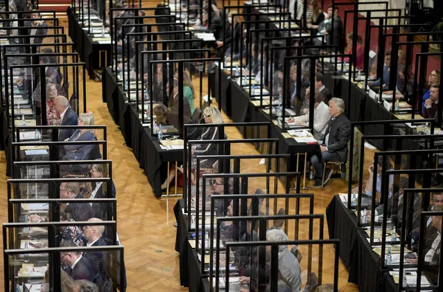 Delegates attend a meeting of the Hamburg state Parliament in Hamburg, Germany, Wednesday, June 10, 2020 at their seats, which are individually separated by Plexiglas panels due to the Corona pandemic. (Photo by Axel Heimken/dpa via AP Photo)