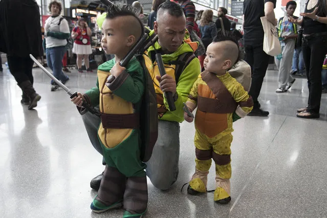 A family of ninja turtles navigating inside New York's Comic-Con convention. (Photo by Siemond Chan)
