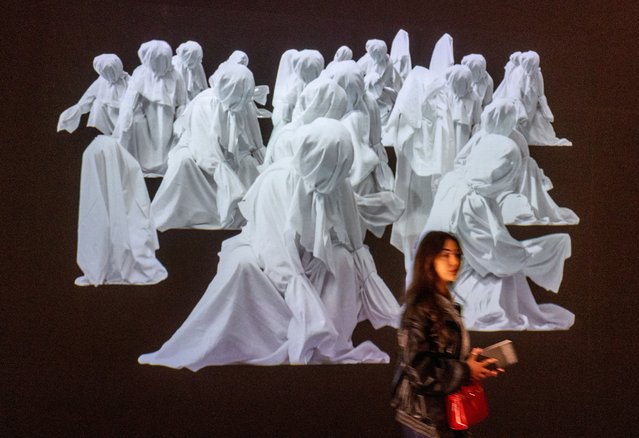 A patient, who is a part of a project in which doctors prescribe museum visits, walks past an artwork in the Art and History Museum in Neuchatel, Switzerland on March 11, 2025. (Photo by Denis Balibouse/Reuters)