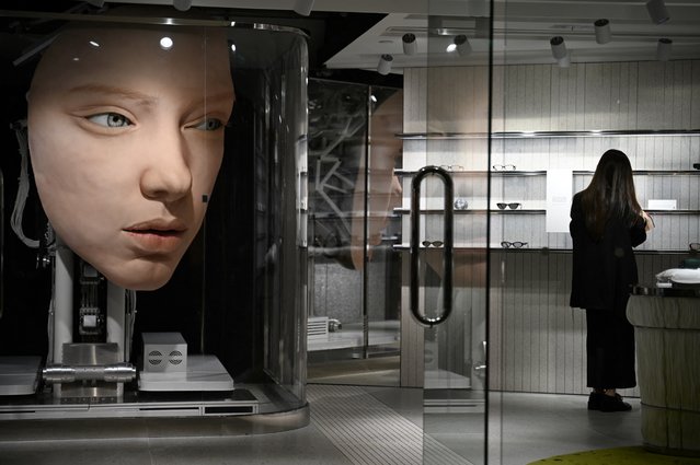 A mechanical face “looks” at people in a boutique store in Hong Kong on April 16, 2025. (Photo by Peter Parks/AFP Photo)