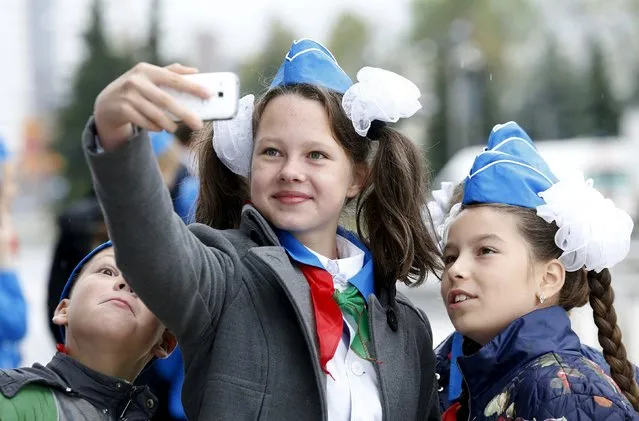 Belarusian schoolchildren take a selfie before celebrations commemorating the 25th anniversary of the country's Young Pioneer movement in Minsk, September 13, 2015. (Photo by Vasily Fedosenko/Reuters)