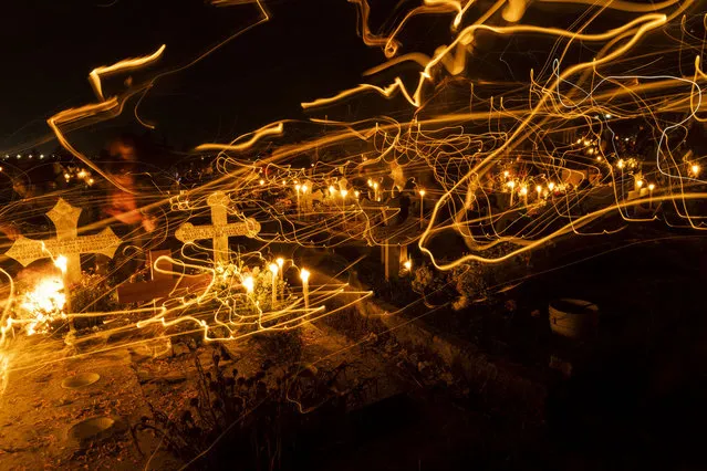 A general view of the San Pablo Autopan cemetery during “Day of the Dead” celebrations on November 1, 2022 in San Pablo Autopan, Mexico. Considered one of the most popular celebrations in Mexico, the Day of the Dead takes place every year on November 1 and 2. The celebration is one of the most colorful and popular in the country; people set offerings, decorate homes and cemeteries and organize family gatherings as a tribute to the dead. (Photo by Cristopher Rogel Blanquet/Getty Images)