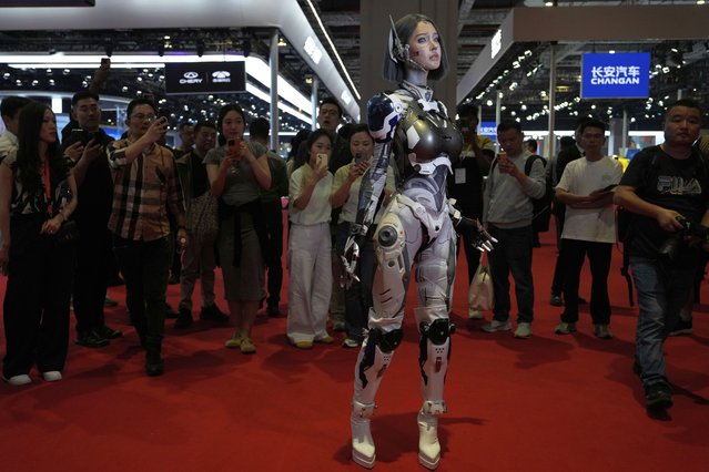 A vlogger who dressed up to look like a humanoid robot poses at the Shanghai auto show on Thursday, April 24, 2025. (Photo by Ng Han Guan/AP Photo)