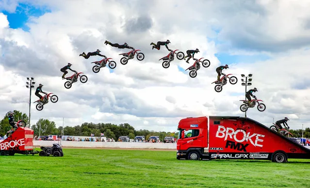 A daredevil motorcyclist performs a stunt during the Peterborough Truckfest 2020 in Peterborough, England on August 30, 2020. (Photo by Terry Harris/Rex Features/Shutterstock)
