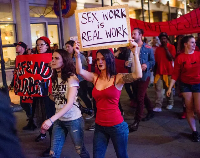 Strip club dancers, workers, and supporters march in in New Orleans on February 1, 2018, to protest the recent police raids that cited and closed several strip clubs on Bourbon Street. Eight clubs in New Orleans have been shuttered for prostitution and drug violations, officials said January 29, as the famed Mardi Gras destination readies for its annual celebrations. Located in and around Bourbon Street, the center of The Big Easy's party scene, the clubs were “served notices of closure” over the past two weeks, New Orleans police chief Michael Harrison said. (Photo by Emily Kask/AFP Photo)