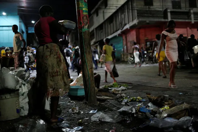 Vendors wait for clients on a street market while Hurricane Matthew approaches in Port-au-Prince, Haiti, October 2, 2016. (Photo by Carlos Garcia Rawlins/Reuters)