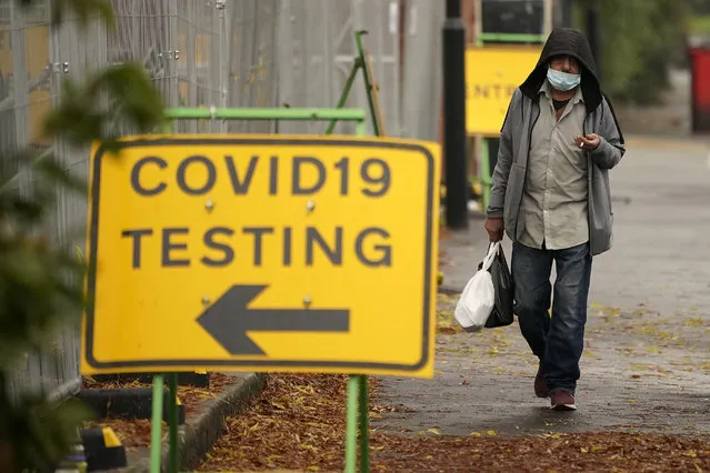 A man walks past a Covid-19 testing site on October 22, 2020 in Sheffield, England. The county of South Yorkshire, which includes the city of Sheffield will move to Tier 3 'Very High' Covid-19 alert on Saturday. (Photo by Christopher Furlong/Getty Images)