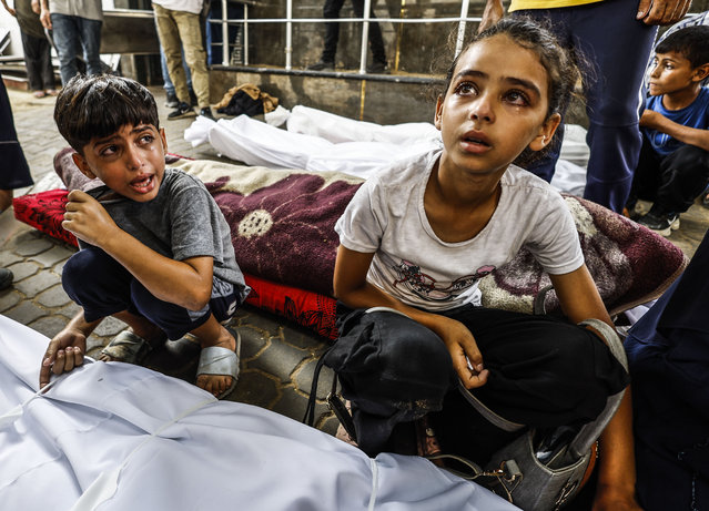 Relatives of the Palestinians, who lost their lives as a result of the Israeli attacks on the public market in the Sheikh Ridan neighborhood where people were waiting for aid, mourn as the dead bodies are brought the Al-Shifa Hospital for burial process on August 13, 2025 in Deir Al Balah, Gaza. (Photo by Mahmoud Issa/Anadolu via Getty Images)