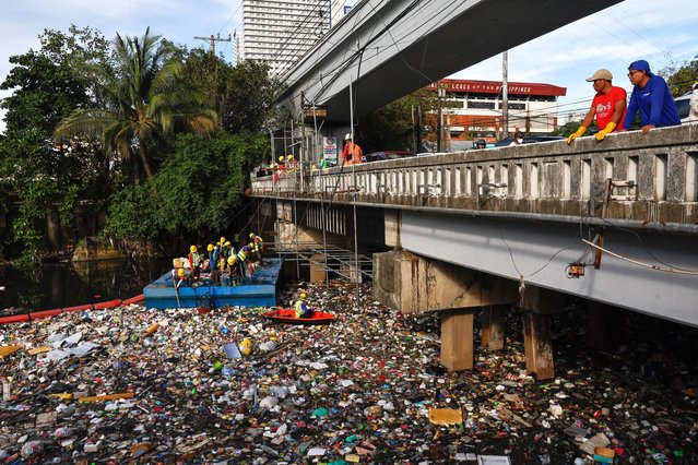 Workers from city environment and sanitation services collect trash and debris from a creek during a clean-up operation at the boundary of San Juan and Quezon City, Metro Manila, Philippines, 20 August 2025. Almost two consecutive weeks of typhoon and heavy monsoon rains in the month of July triggered massive flooding in Metro Manila and several regions of the Philippines, leading local government units to intensify flood control measures and to improve waste management protocols. (Photo by Rolex Dela Pena/EPA)