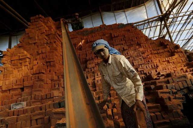People work in a brick factory at the outskirts of Yangon November 4, 2015. (Photo by Jorge Silva/Reuters)