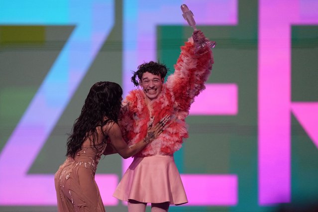 Nemo of Switzerland, who performed the song The Code, celebrates with last year's winner Loreen of Sweden after winning the Grand Final of the Eurovision Song Contest in Malmo, Sweden, Saturday, May 11, 2024. (Photo by Martin Meissner/AP Photo)
