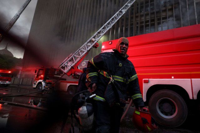 A firefighter reacts after a fire erupted in a telecommunications building in the Ramses district of downtown Cairo, Egypt on July 7, 2025. (Photo by Amr Abdallah Dalsh/Reuters)