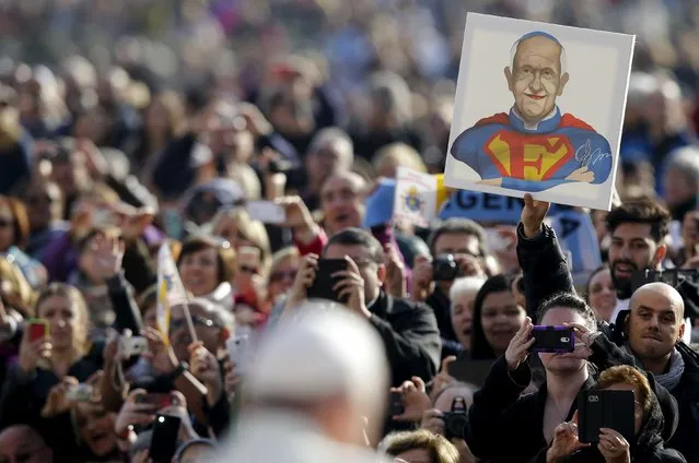 Pope Francis is seen in front of a painting depicting him as Superman during the weekly audience in Saint Peter's Square at the Vatican November 11, 2015. (Photo by Max Rossi/Reuters)