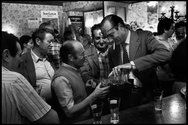 Correze, France, 1982. Jacques Chirac (right), president of the RPR Party, drinks with voters in a bar while visiting his constituency. (Photo by Abbas Attar/Magnum Photos)