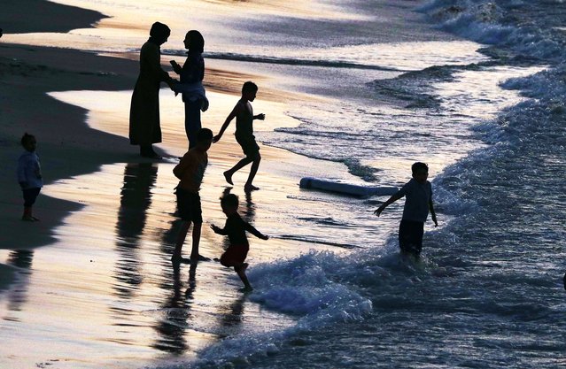 Palestinians spend their time at the beach at sunset amid a ceasefire between Israel and Hamas in the west of Gaza City, on 31 October 2025. (Photo by Mohammed Saber/EPA)