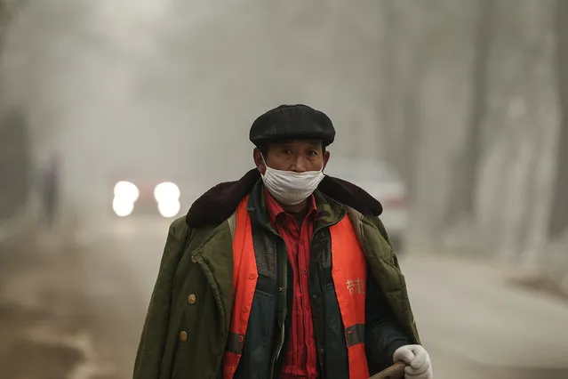 A Chinese worker wearing a mask on a day of heavy pollution on December 1, 2015 in Beijing, China. China's capital and many cities in the northern part of the country recorded the worst smog of the year with air quality devices in some areas unable to read such high levels of pollutants. Levels of PM 2.5, considered the most hazardous, crossed 600 units in Beijing, nearly 25 times the acceptable standard set by the World Health Organization. (Photo by Lintao Zhang/Getty Images)