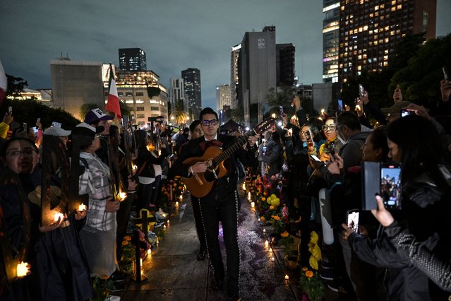 A Mariachi performs as judicial employees protest at the Revolucion monument in Mexico City on September 30, 2024. During the protest, called “Mega Altar of the Dead, The Legacy of the Sexenio”, judicial workers protested against the outgoing Mexican President Andres Manuel Lopez Obrador. (Photo by Yuri Cortéz/AFP Photo)