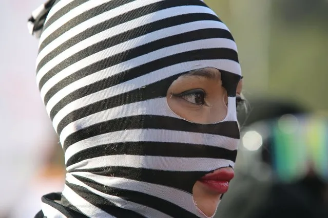 A demonstrator with her face covered joins a march making the International Day for the Elimination of Violence Against Women, in Mexico City, Wednesday, November 25, 2020. (Photo by Ginnette Riquelme/AP Photo)