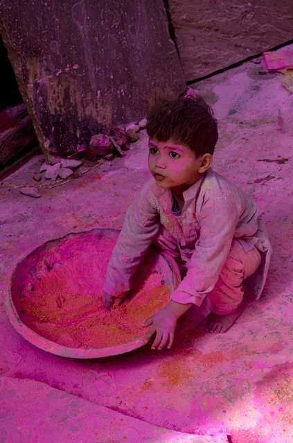 “Child playing with color”. This child was playing Holi festival of color. Location: Vrindavan, India. (Photo and caption by Anirudha Robi Chakraborty/National Geographic Traveler Photo Contest)
