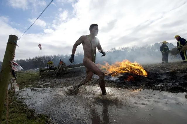 A competitor take part in the “Tough Guy” adventure race near Wolverhampton, Staffordshire, West Midlands, on February 1, 2015. The event challenges thousands of competitors to run through a gruelling 200 obstacles including water, fire, and tunnels after a lengthy run at the start. (Photo by Oli Scarff/AFP Photo)