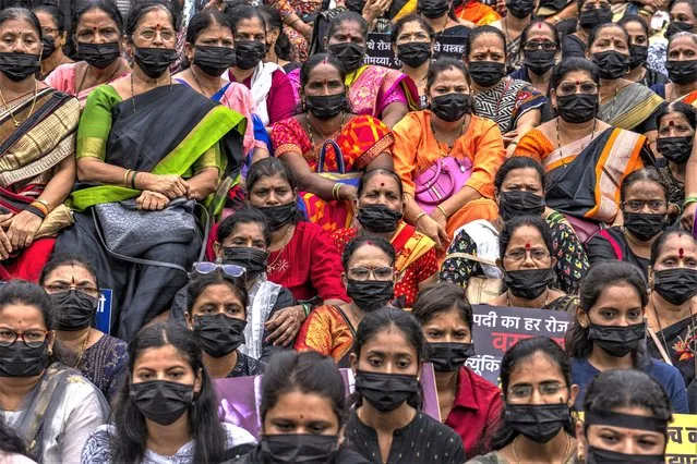 Supporters Shiv Sena wearing black masks sit on a silent protest for calling for an end to violence against women in Mumbai, India, Wednesday, August 2, 2023. (Photo by Rafiq Maqbool/AP Photo)