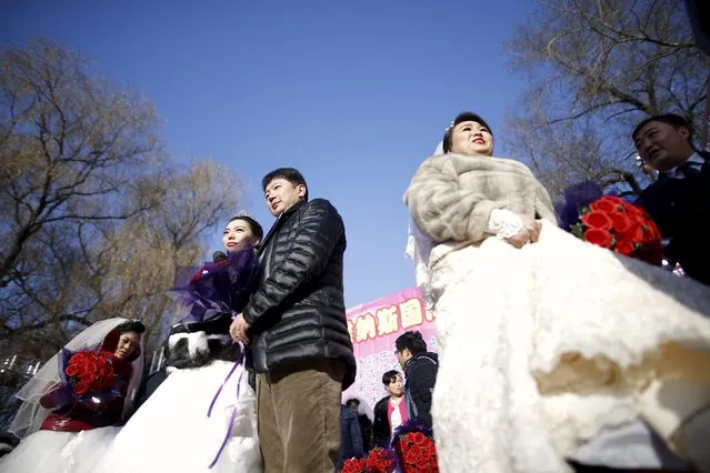 Newly-wed couples attend their group wedding ceremony which was held as part of the Harbin International Ice and Snow Festival in the northern city of Harbin, Heilongjiang province January 6, 2016. (Photo by Aly Song/Reuters)