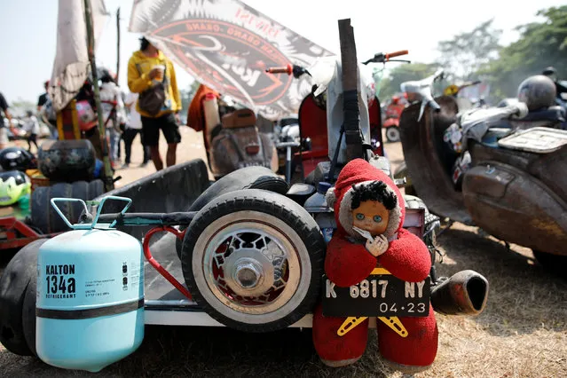 A stuffed toy mascot is tied to the back of an extreme Vespa at a weekend festival for extreme Vespas in Semarang, Central Java, Indonesia, July 22, 2018. (Photo by Darren Whiteside/Reuters)