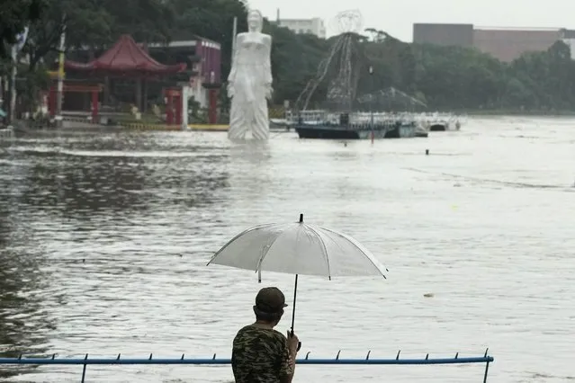 A man looks at a riverside park that was flooded due to enhanced rains brought about by Typhoon Doksuri on Thursday, July 27, 2023, in Marikina city, Philippines. Typhoon Doksuri lashed northern Philippine provinces with ferocious wind and rain Wednesday, leaving several people dead and displacing thousands of others as it blew roofs off houses, flooded low-lying villages and triggered dozens of landslides, officials said. (Photo by Aaron Favila/AP Photo)
