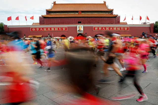 Participants run past Tiananmen gate during the Beijing Marathon in Beijing, China, September 16, 2018. (Photo by Damir Sagolj/Reuters)